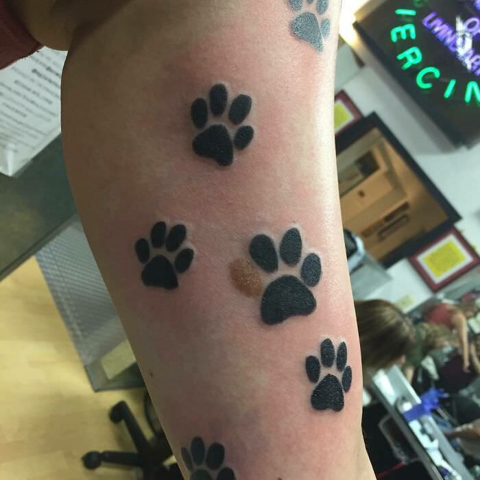 Paw print tattoo around a birthmark