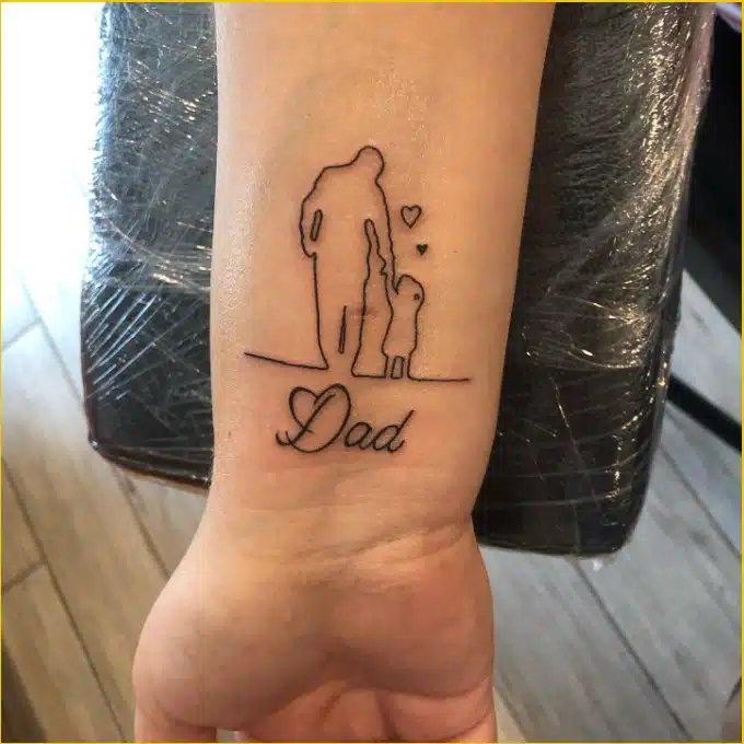 A beautiful tattoo design that symbolizes a daughter's love and appreciation for her father, etched on the wrist.