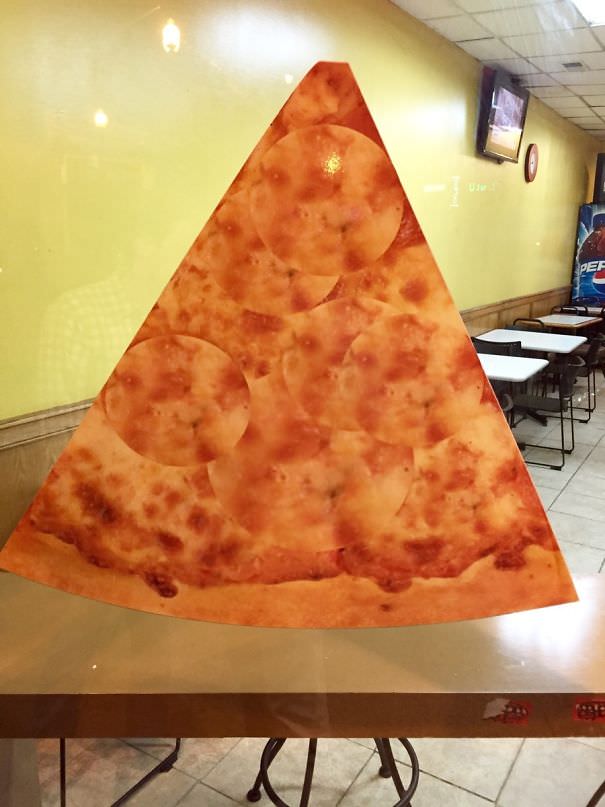 This pizza place photoshopped a pepperoni pizza into a cheese pizza in this photo.