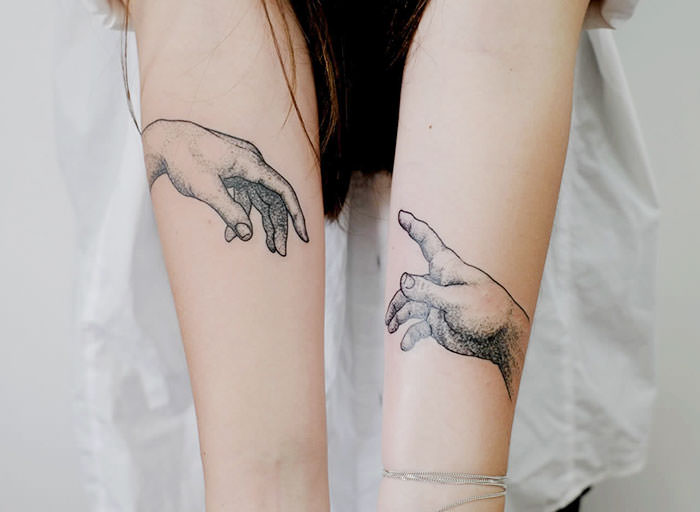 A tattoo of Michelangelo's "The Creation of Adam"
