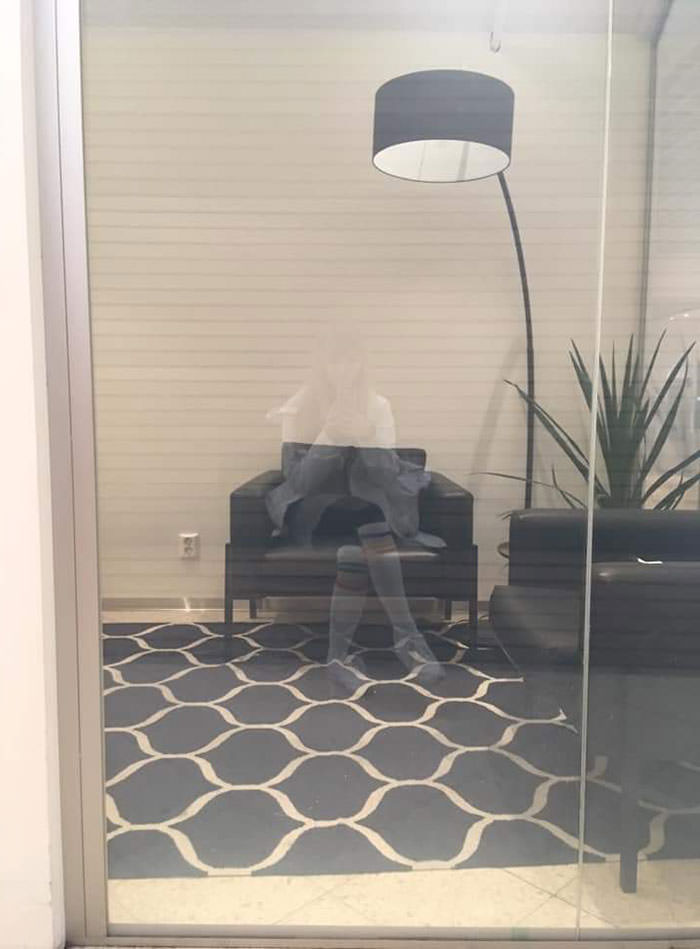 A reflection in a window that perfectly fits in a chair.