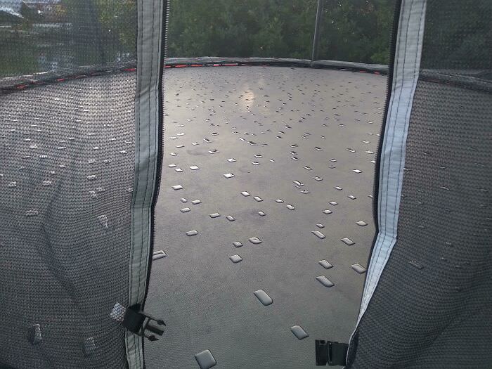 Dew forming on a trampoline that is squared out by the fabric.