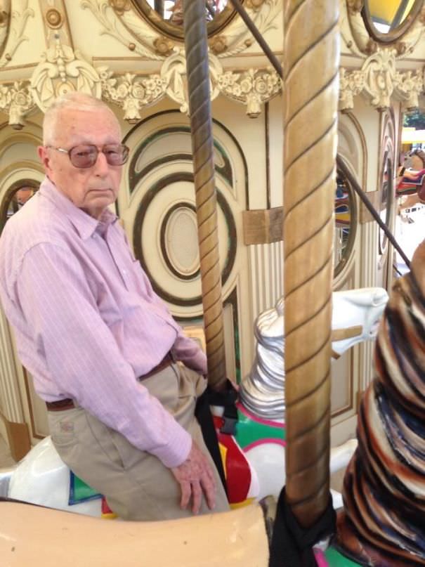 Someone's sister managed to get their grandfather on a carousel.