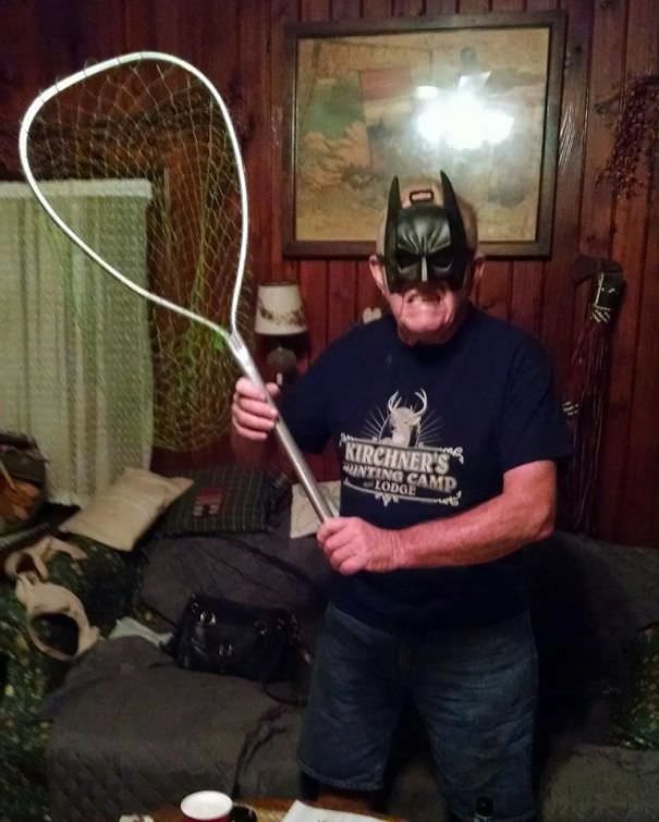 Grandpa gets ready to catch bats in his bat-catching gear.