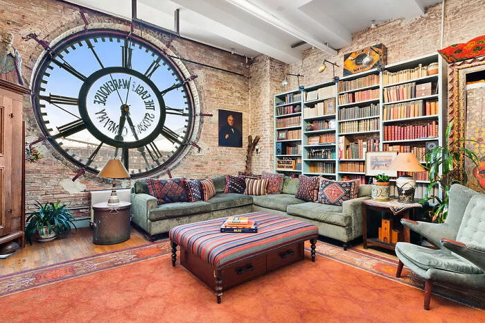 A loft in an old warehouse with views of the Brooklyn Bridge through the clock window, available for $2.35 million