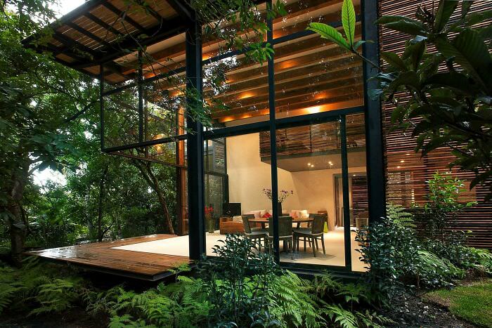 An open air living space connected to a deck surrounded by the greenery of Valle de Bravo, Mexico