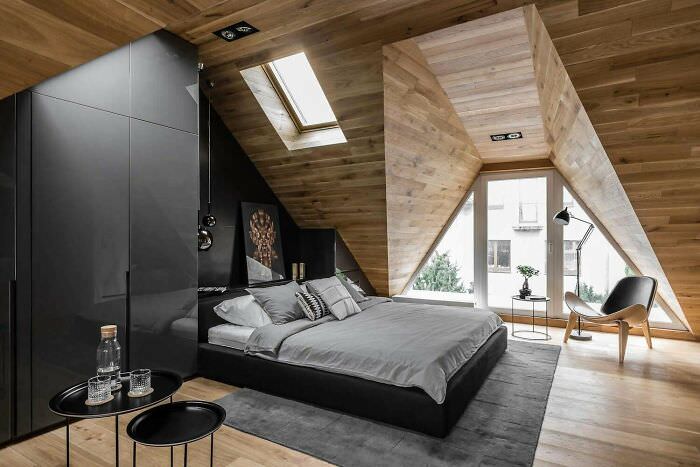 An attic bedroom designed to capture light in an apartment in Sopot, Poland