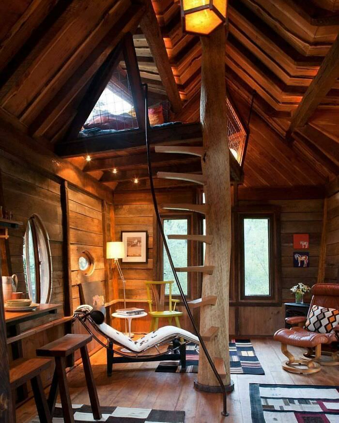 A treehouse living area with a sleeping loft located near the Crystal River in Colorado.