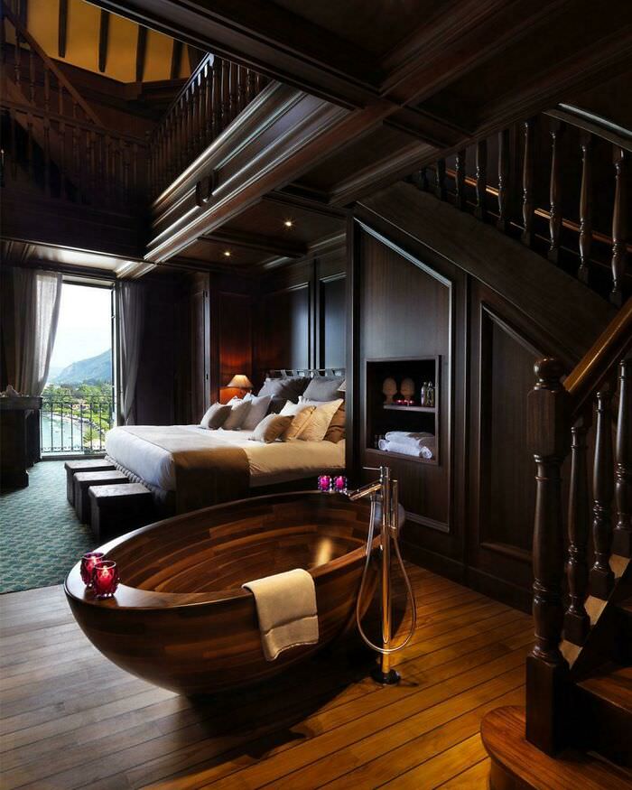 A dark and elegant bedroom suite nestled under the stairs.