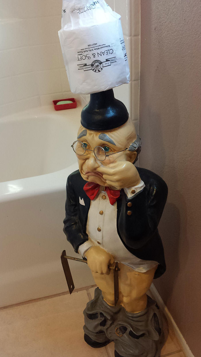 This figurine in the bathroom of the rental house i'm staying at. Why is he sniffing his finger?