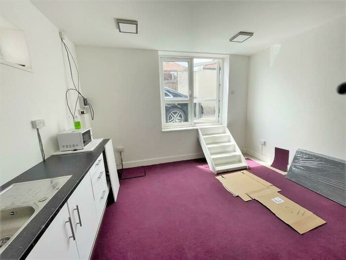 This apartment in London has no front door, just a set of stairs leading up to a window.
