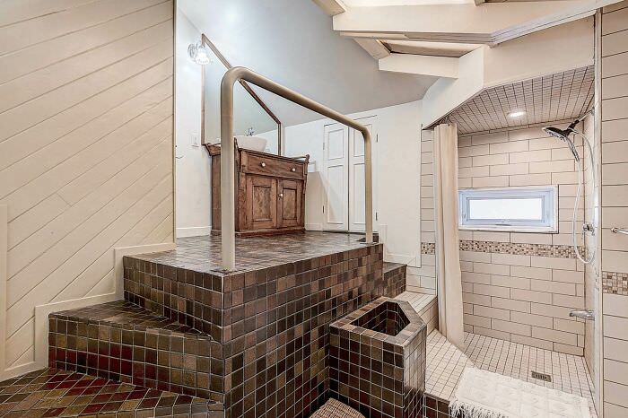 Two staircases in the bathroom are better than one; the toilet is behind the wall on the left.