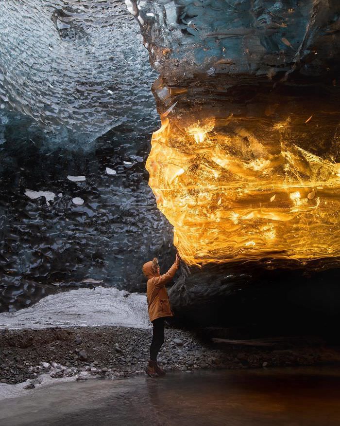 The cave was lit up with golden rays of the sunset that illuminated this section of ice, making it look like amber.