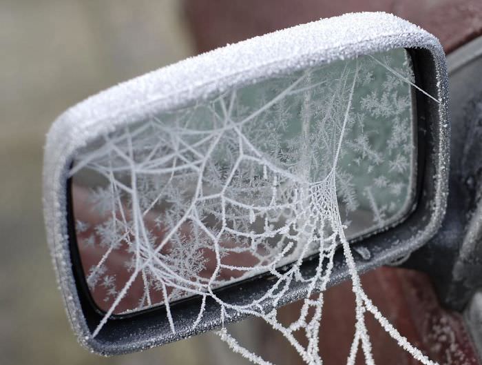 Ice spider webbed on a car.