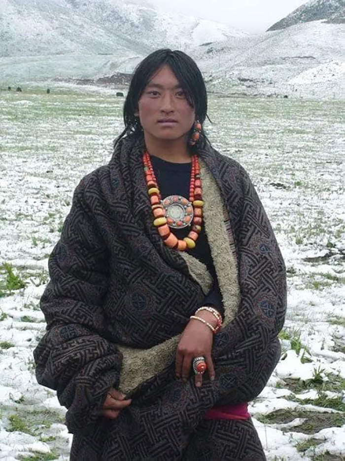 Tibetan man wearing Tibetan jewelry and ethnic clothes.