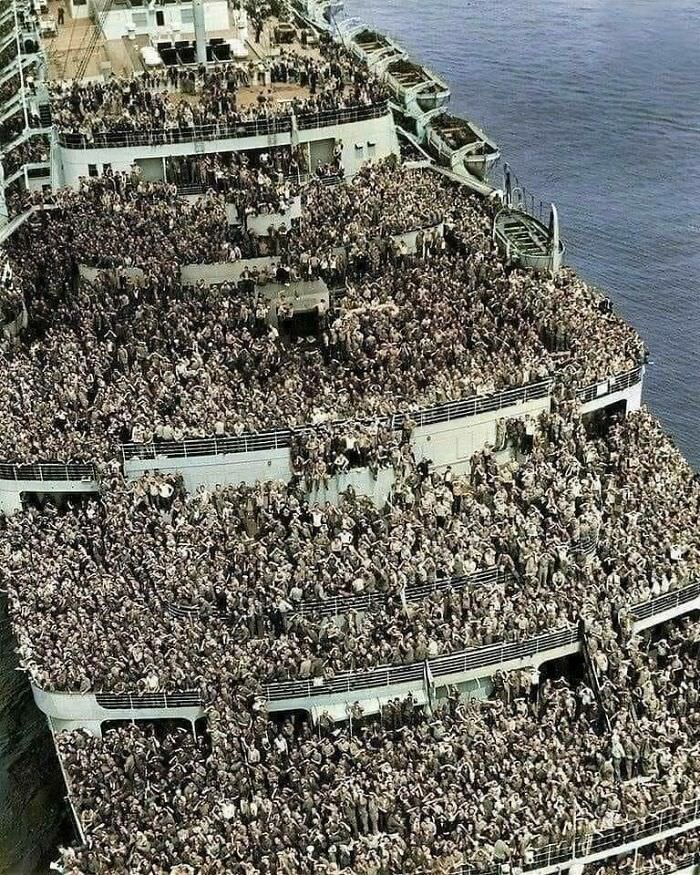 A truly amazing photo! The RMS Queen Elizabeth pulling into New York with servicemen returning home after the end of World War II, 1945.