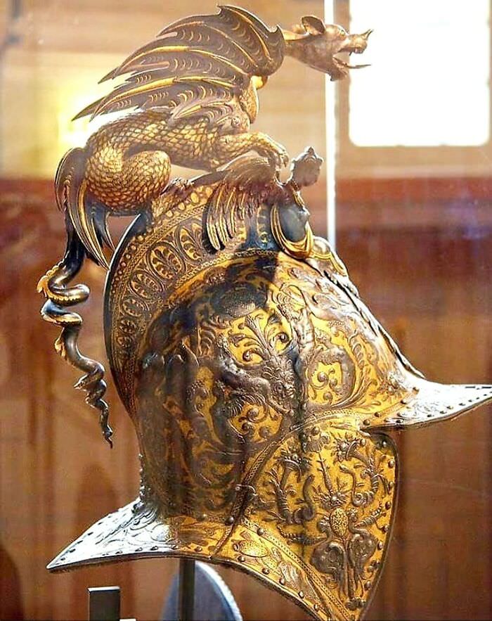 Renaissance period, 1560-1570: The extraordinary parade steel gilt burgonet chimera helmet created for the wedding of the Duke of Alba.