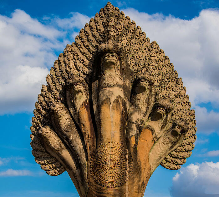 Angkor Wat, Cambodia: 7-headed snake (naga) statue. In Indian mythology, half-serpent, half-human beings called nagas were seen as guardians of rivers, wells, springs, and all sources of drinking water.