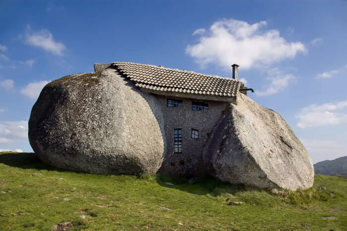 Stone House in Celorico de Basto, Northern Portugal. It is called Casa do Penedo (House of the Rock) because it was built from four large boulders serving as the foundation, walls, and ceiling. Constructed in 1972.