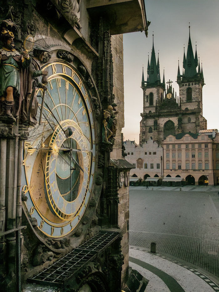 Prague, Czech Republic: Astronomical clock on Old Town Square and Church of Our Lady before Týn at golden hour.