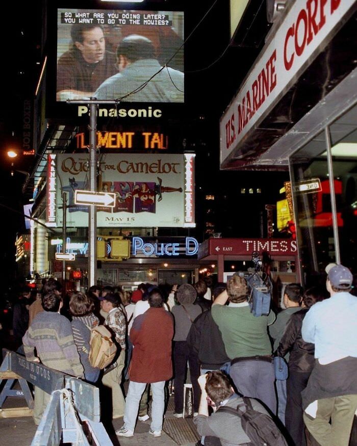 People stop to watch the "seinfeld" finale in times square, 25 years ago