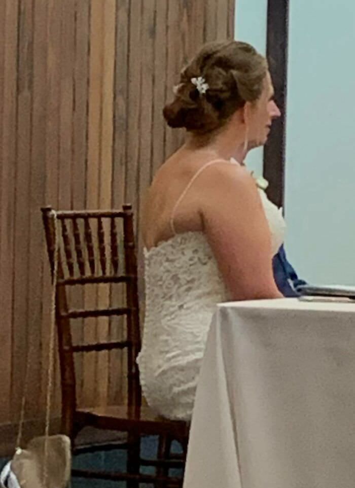 Groom's nose caught in a photo of the wedding table
