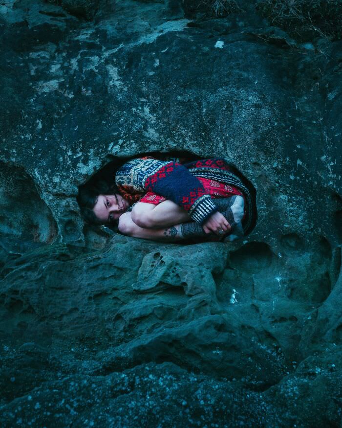 Friend fitting snugly in a rock wall nook