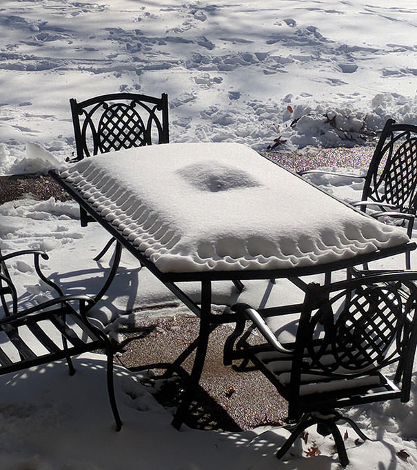 The snow on this patio table looks like a pastry pie