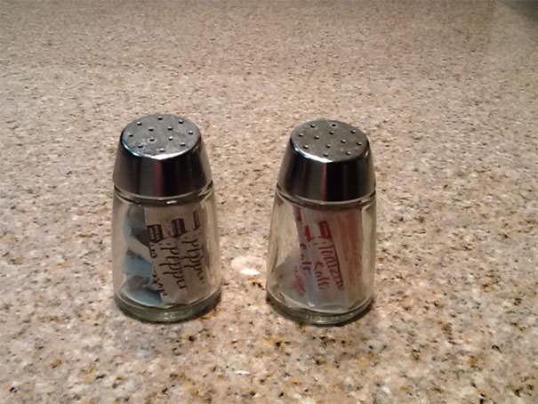 These salt and pepper shakers have individual salt and pepper packets inside of them.