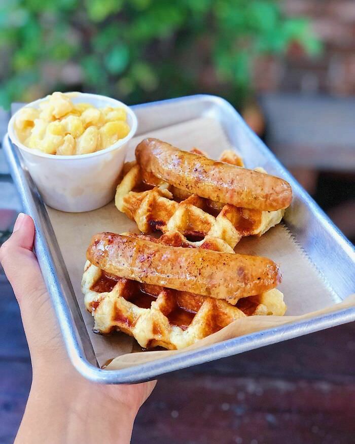 Spicy chicken andouille sausage on top of a pearl sugar Belgian waffle, drizzled with maple syrup. My mouth just watered typing that.