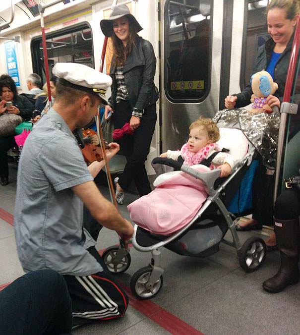 A man spent his subway ride playing his violin for a baby because it was crying.