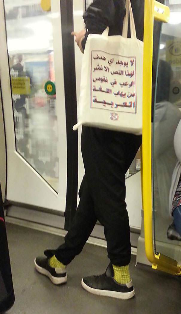 Meanwhile, in a Berlin metro, the text on the bag reads: "This text has no other purpose than to terrify those who are afraid of the Arabic language."