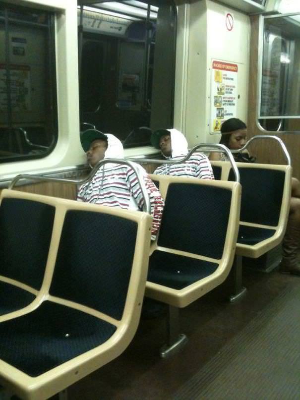 There are two identical-looking people sleeping on the subway.