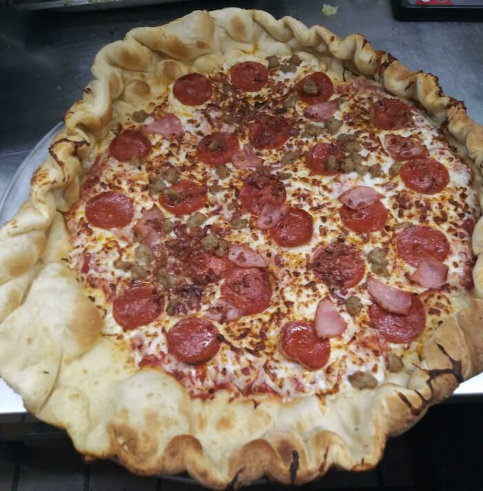 A new employee didn't pinch the dough while making the crust. This is the result