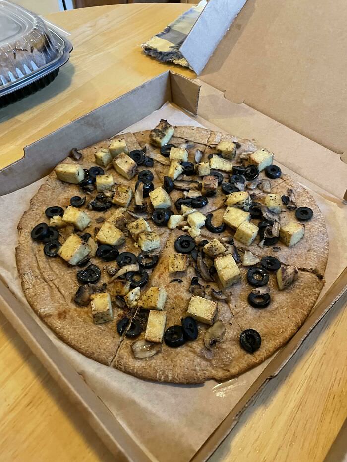 My (vegan) daughter's go to pizza: tofu, black olives and mushrooms with olive oil and herb sauce on a whole wheat crust