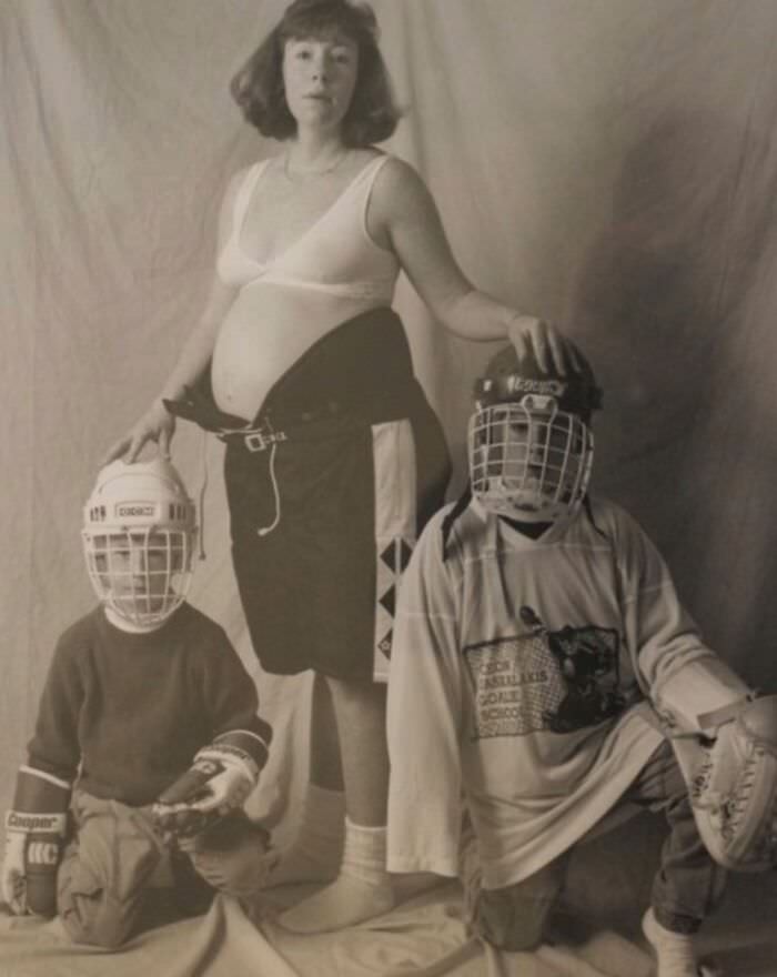 This is a photo of my mom, my brother, myself, and my soon-to-be-born younger brother. I’m awkwardly in the hockey equipment on the bottom left.
