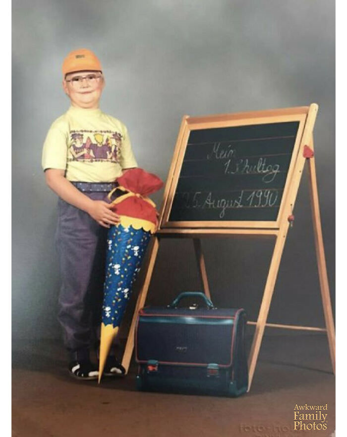 My husband’s 1st day of school dressed in a cap that looks like a helmet, old school glasses and white socks & sandals while holding his school-issued ‘schultuete’