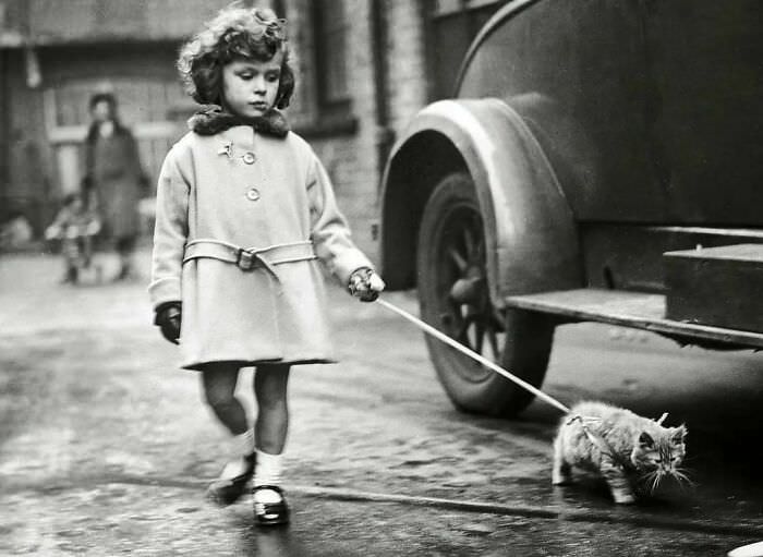 A girl and her kitten, 1931.