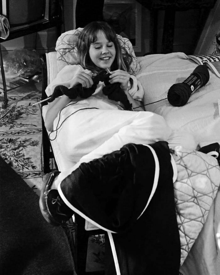 Linda Blair passes the time with a bit of knitting in between takes while filming on the set of The Exorcist.