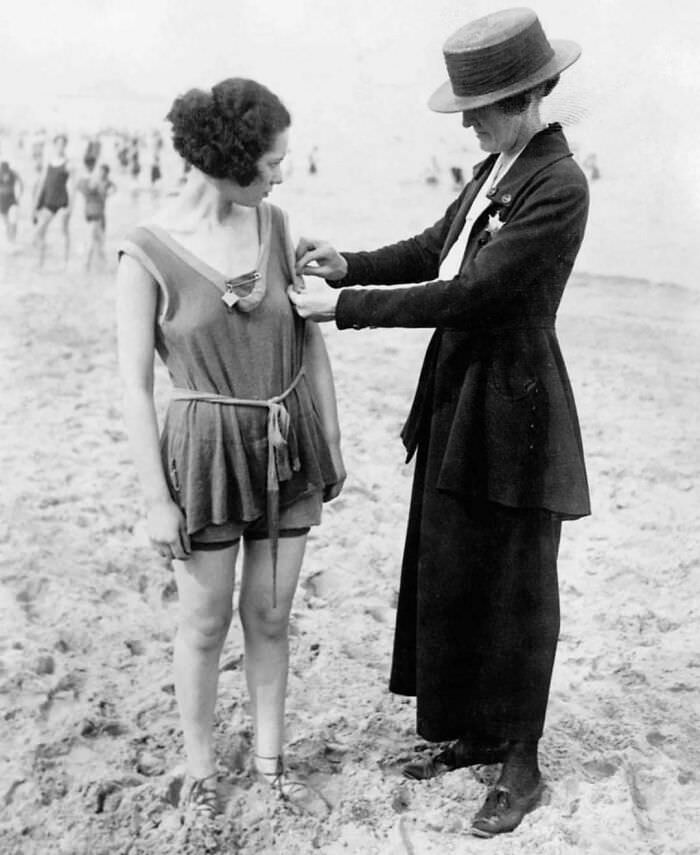 Woman being arrested for wearing one-piece bathing suits, 1920s.