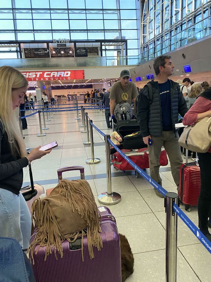 This girl at the airport waits until the queue moves all the way forward to move. People confronted her, and she said, “It’s the same if I move now or later”.