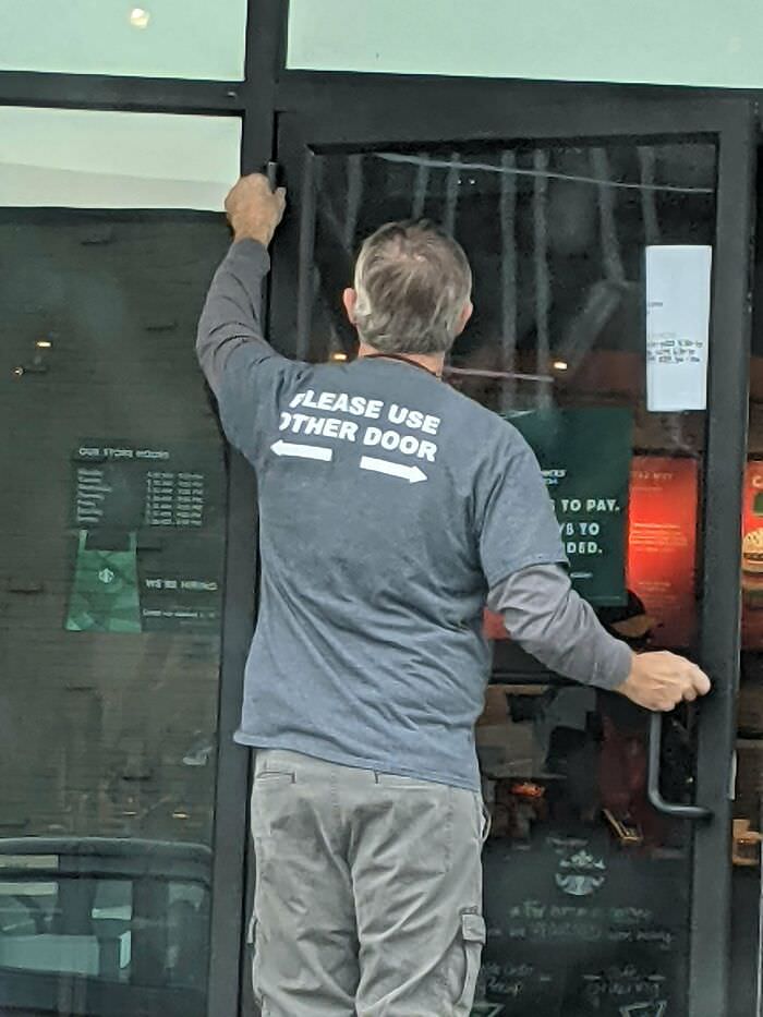 This maintenance guy's shirt doubles as a sign.