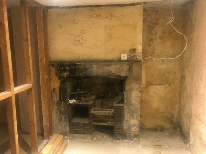 A wall was removed in a Victorian house we are working at which revealed an old cast iron fireplace.