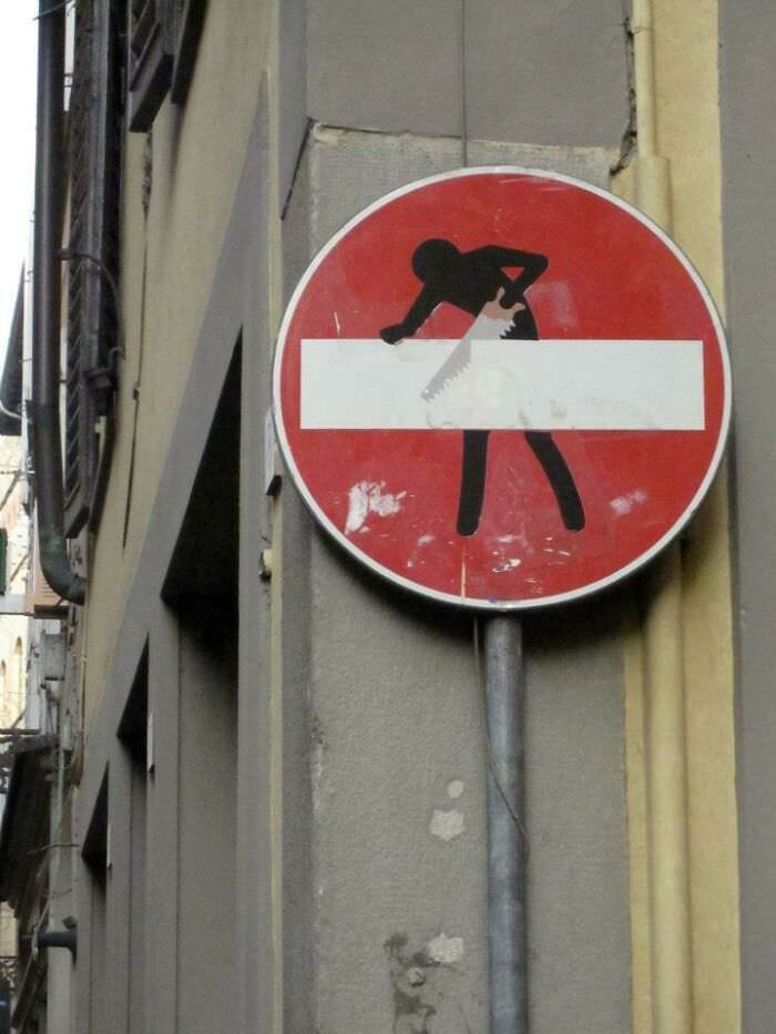This stop sign in Rome has a stick figure sawing the -