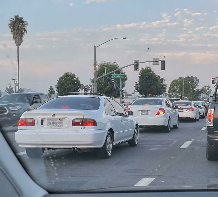 I saw 4 generations of Honda Civics, in order of age, all in white.
