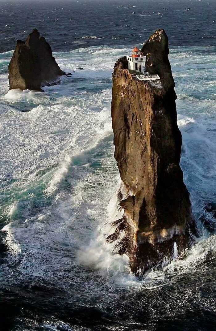 Lighthouse perched on a rock pillar in the Westman Islands, Iceland.