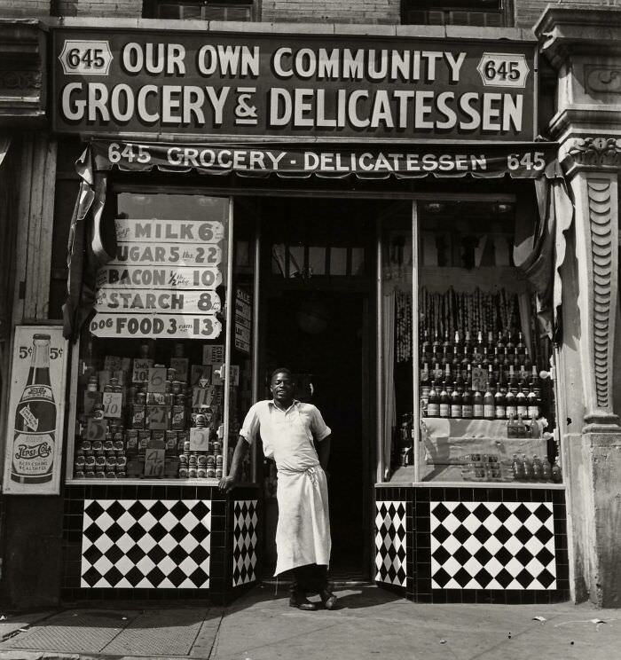 Proud community grocery store owner, Harlem, 1940.