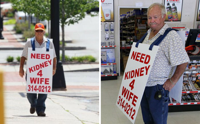 Man walks the streets with a sign to find a kidney donor for his wife.