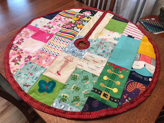 I made this tree skirt by quilting my daughter's old baby clothes for my wife this Christmas.