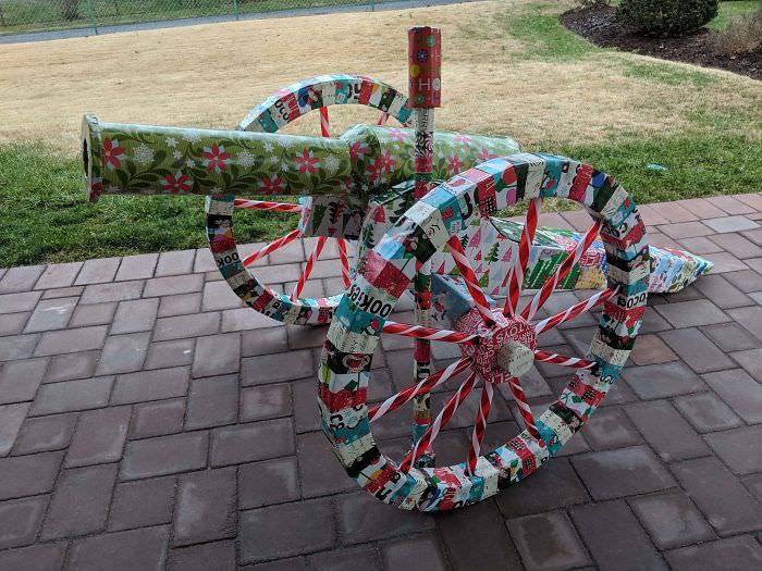 Our family has a 35+ year tradition of disguising Christmas gifts. This took over 80 hours to build. This "cannon" is actually disguising a golf umbrella, hidden in the ramrod. The cannon is made out of cardboard, with a little foam for structural support, plus the candy cane spokes. The cannon has a remotely triggered CO2 canister hooked to a solenoid valve to launch a Christmas ornament on command.